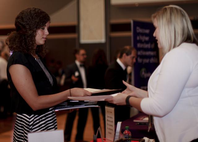 Student handing their resume to an employer