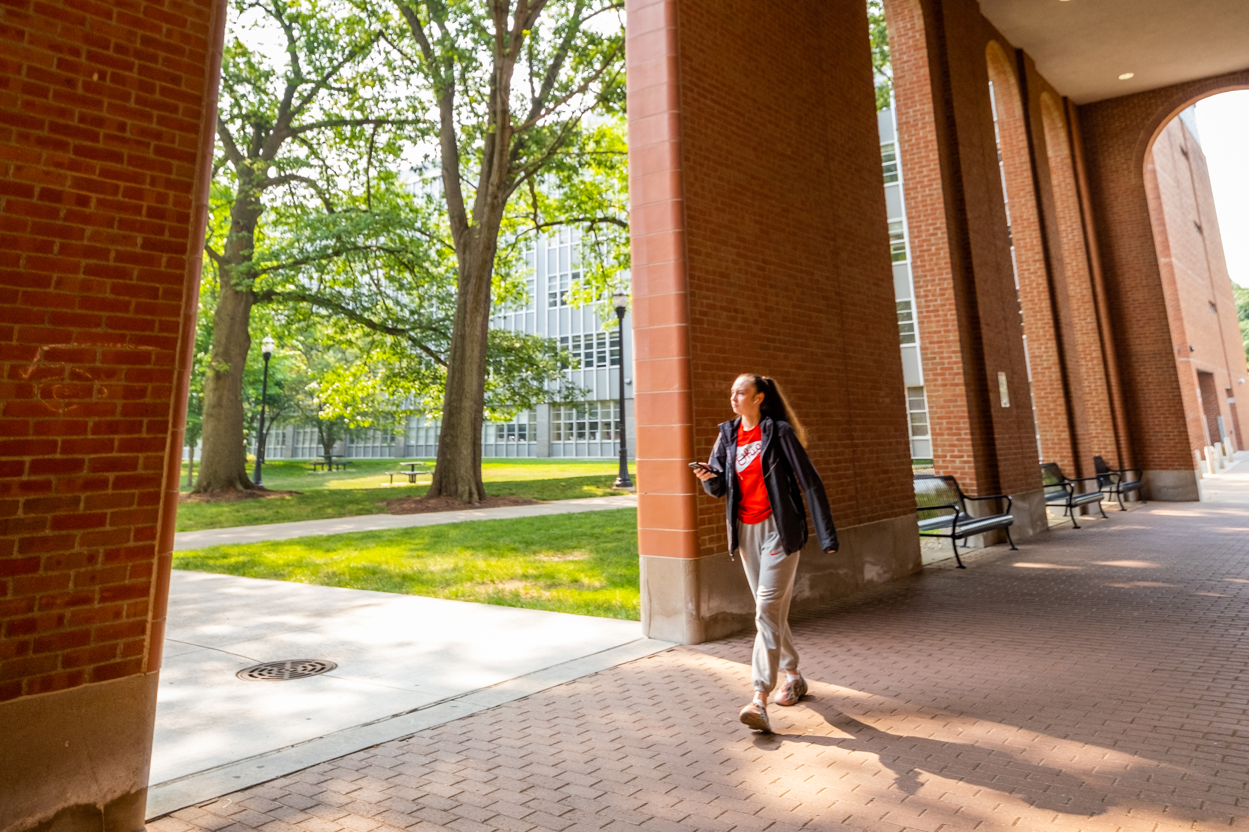 Person walking through a sunny corridor in the summer